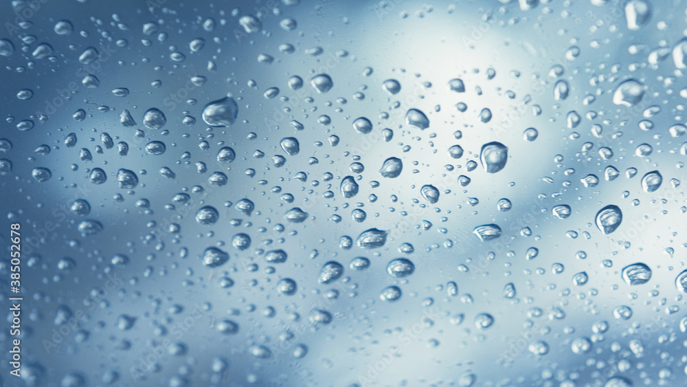 Real water drops on blue gradation background, close up. Raindrops on the window glass. Condensation Real water drops on blue gradation background, close up. Raindrops on the window glass. Condensation
