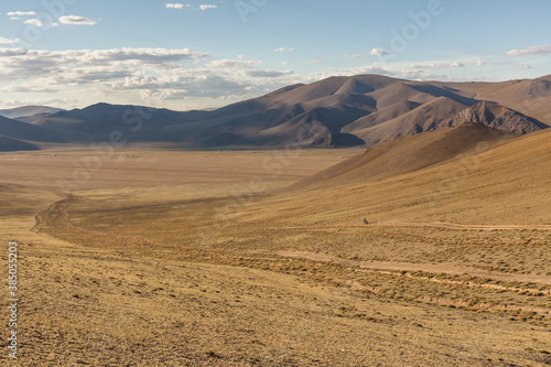 Mongolia landscape with nomad yurts in Altai. Mongolian nomad on a motorcycle