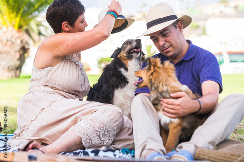 Photography Happy caucasian adult couple enjoy two dogs in alternative family and best frien