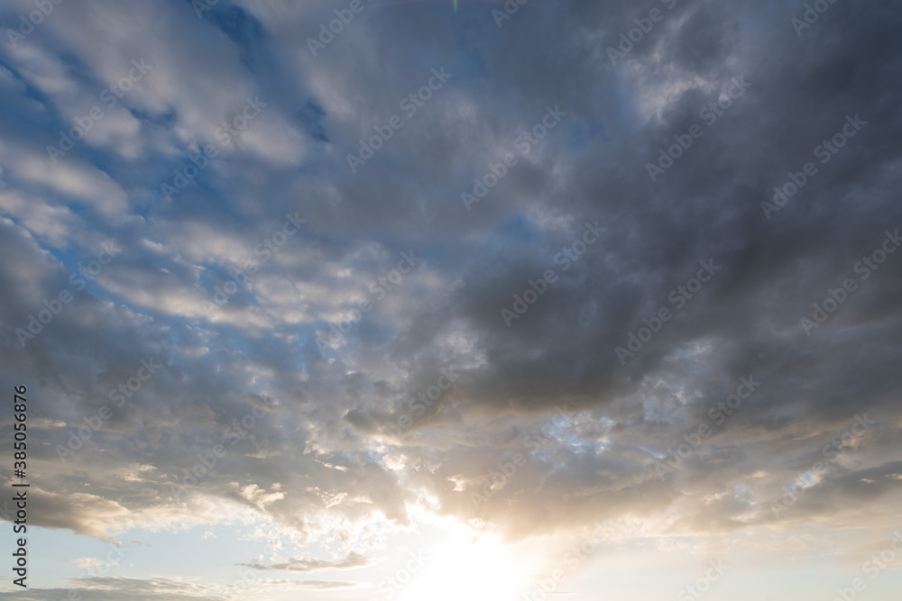 View into sunset with cloudy sky in the evening sun.