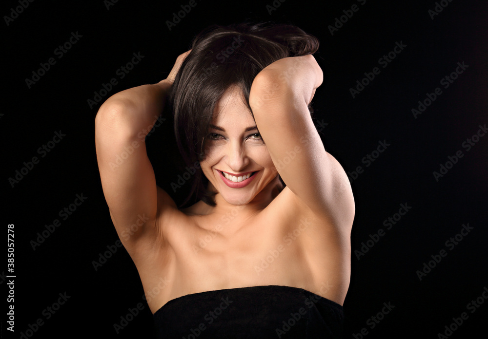 Beautiful happy laughing bright makeup woman shaking her black short hair on black background. Closeup portrait Beautiful happy laughing bright makeup woman shaking her black short hair on black background. Closeup portrait
