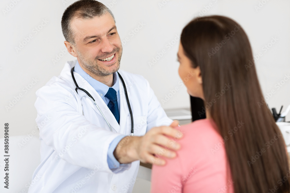 Happy male doctor telling good news to his patient Happy male doctor telling good news to his patient