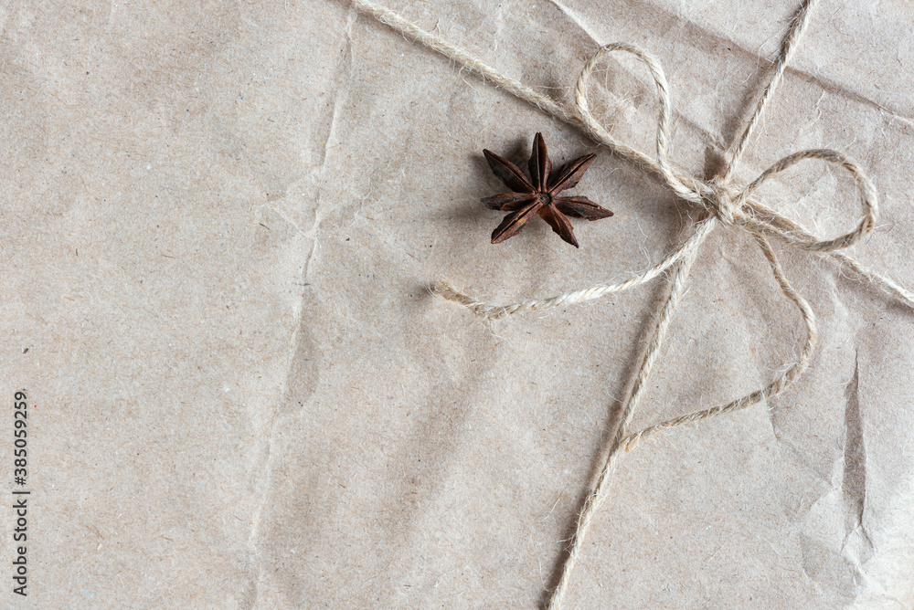 Christmas gift wrapped in kraft paper with star anise Christmas gift wrapped in kraft paper with star anise
