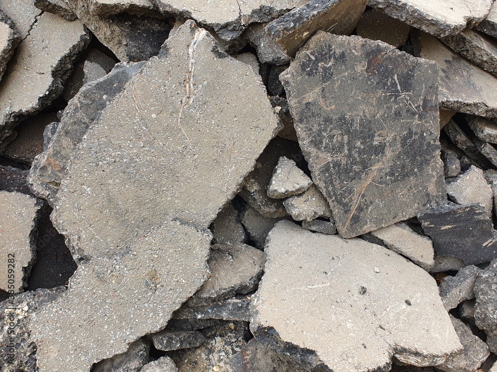 Fototapeta premium A mountain of pieces of old asphalt removed before the new asphalt was laid.