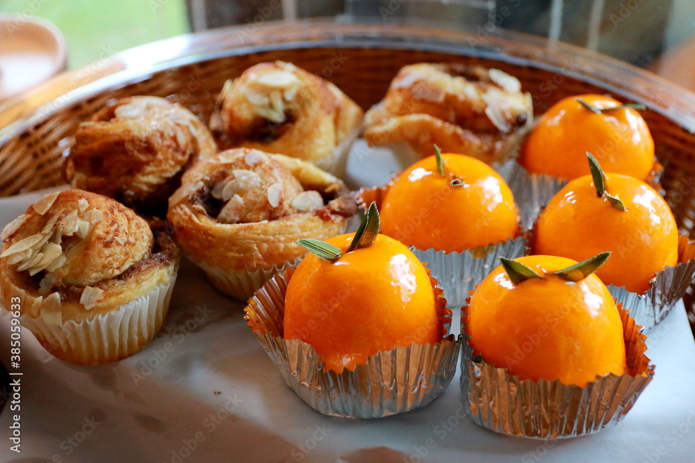 Orange cake and cup cake in basket for coffee break. Orange cake and cup cake in basket for coffee break.