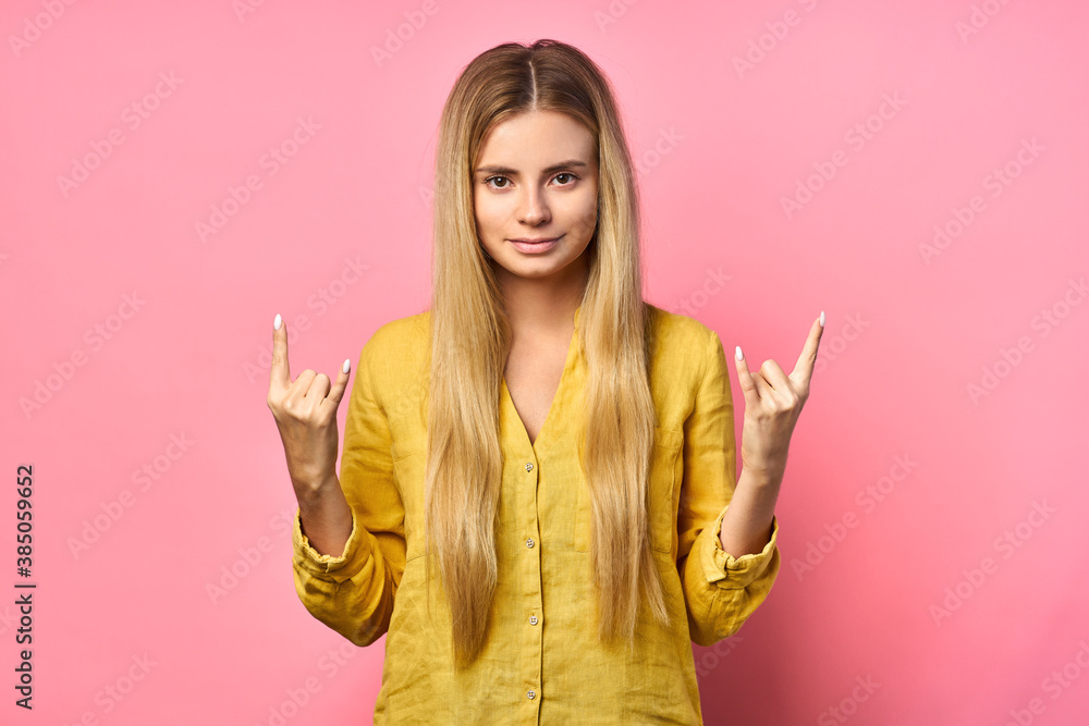 emotional portrait of attractive cheerful excited blonde. Shouts, rejoicing in success, victory. isolated on yellow background emotional portrait of attractive cheerful excited blonde. Shouts, rejoicing in success, victory. isolated on yellow background