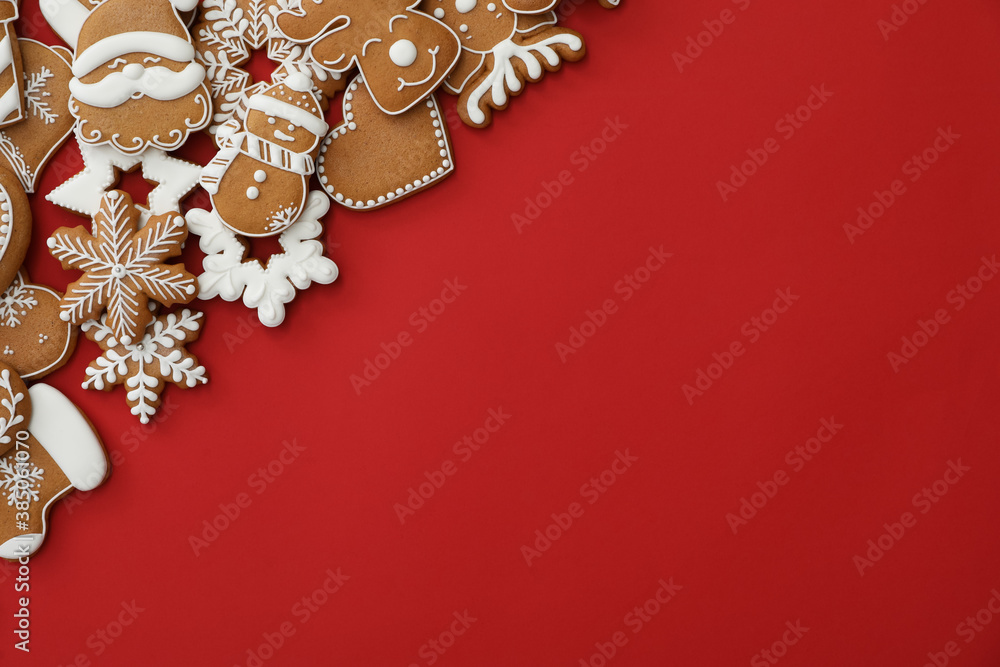 Fototapeta premium Different Christmas gingerbread cookies on red background, flat lay. Space for text