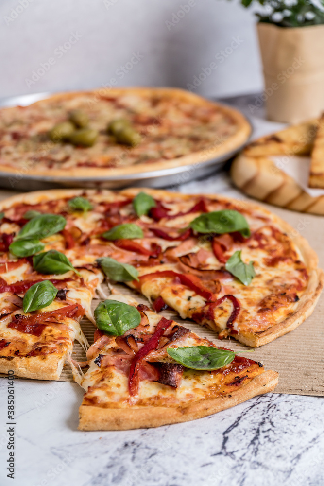 delicious homemade pizza with sauce, cheese ready to eat on white marble