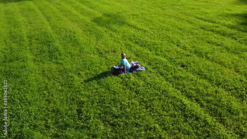 Young adult male peace quiet and relax alone in nature. Circle drone footage. Young adult male peace quiet and relax alone in nature. Circle drone footage.