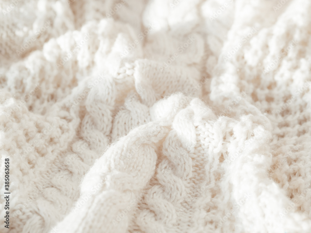 Hand made cable-knit sweater sweater. Texture of warm knitted fabric with pattern. White crumpled cardigan. Cozy autumn outfit for snuggle weather. Hand made cable-knit sweater sweater. Texture of warm knitted fabric with pattern. White crumpled cardigan. Cozy autumn outfit for snuggle weather.