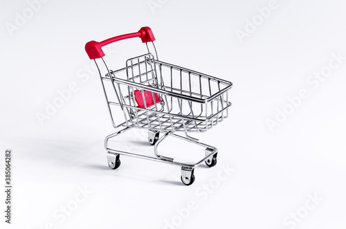 red empty cart on a white background close up concept of trade © Лозовая Людмила
