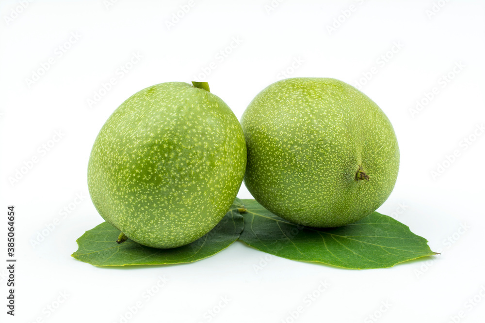 Two walnuts in peel isolated on white background. Two walnuts in peel isolated on white background.