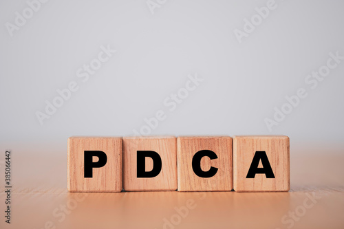 Fototapeta Naklejka Na Ścianę i Meble -  Plan do check action concept , PDCA printed screen on wooden cube block.