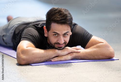 man doing yoga at outdoor in city.