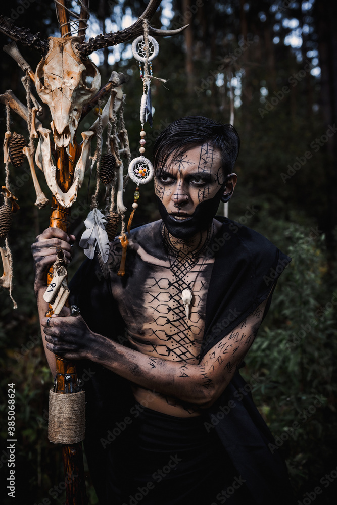Sorcerer with marks on his body in the forest Sorcerer with marks on his body in the forest