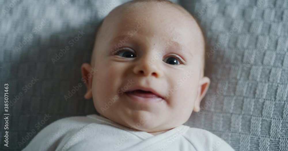 Authentic close up shot of a cute newborn baby is smiling in the camera. Authentic close up shot of a cute newborn baby is smiling in the camera.