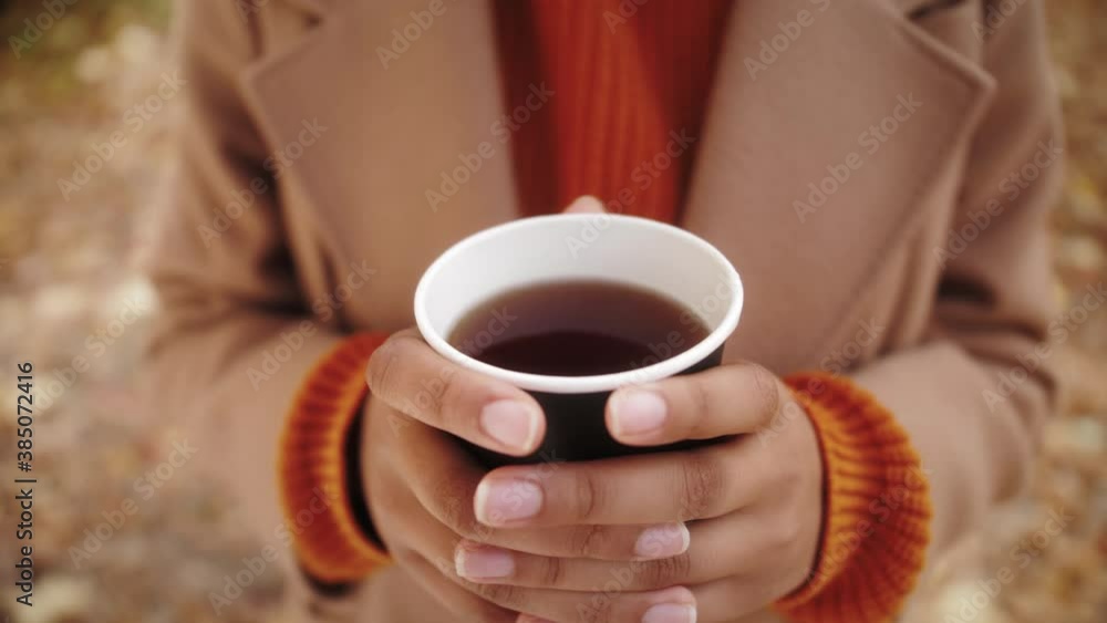 Autumn composition, black african american Woman's hands with cup of coffee, cappuccino, latte coffee. autumn leaves, craft envelope and paper, Hot drink close up Autumn composition, black african american Woman's hands with cup of coffee, cappuccino, latte coffee. autumn leaves, craft envelope and paper, Hot drink close up
