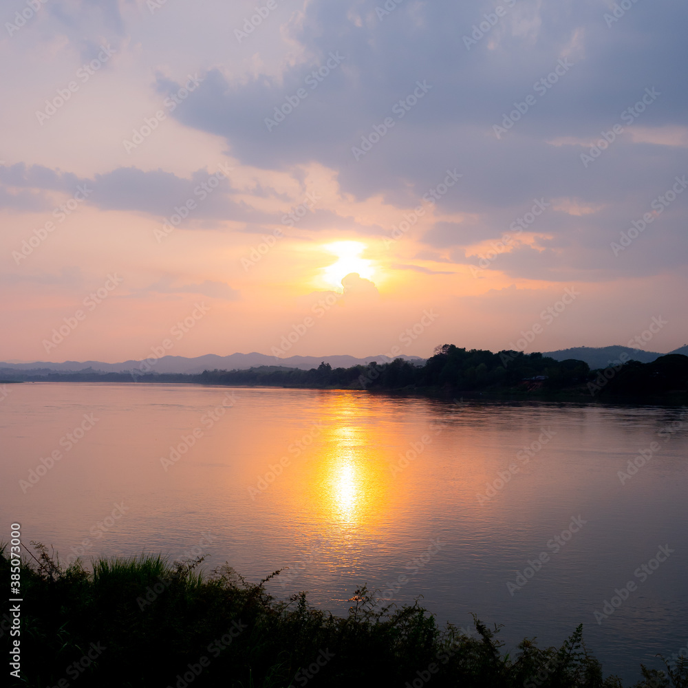 sunset over river in Thailand