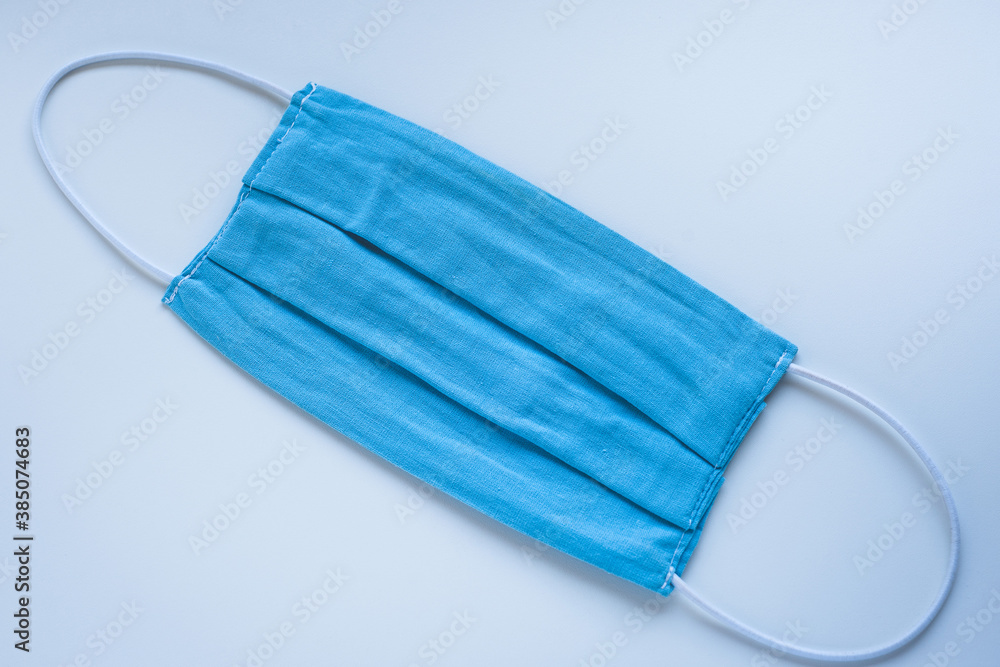 Fabric protective face mask on a blue background Fabric protective face mask on a blue background