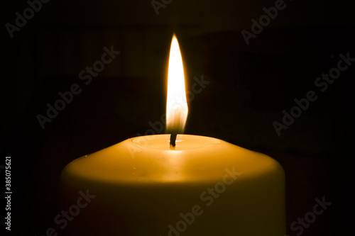The flame of the candle that illuminates the bright red light