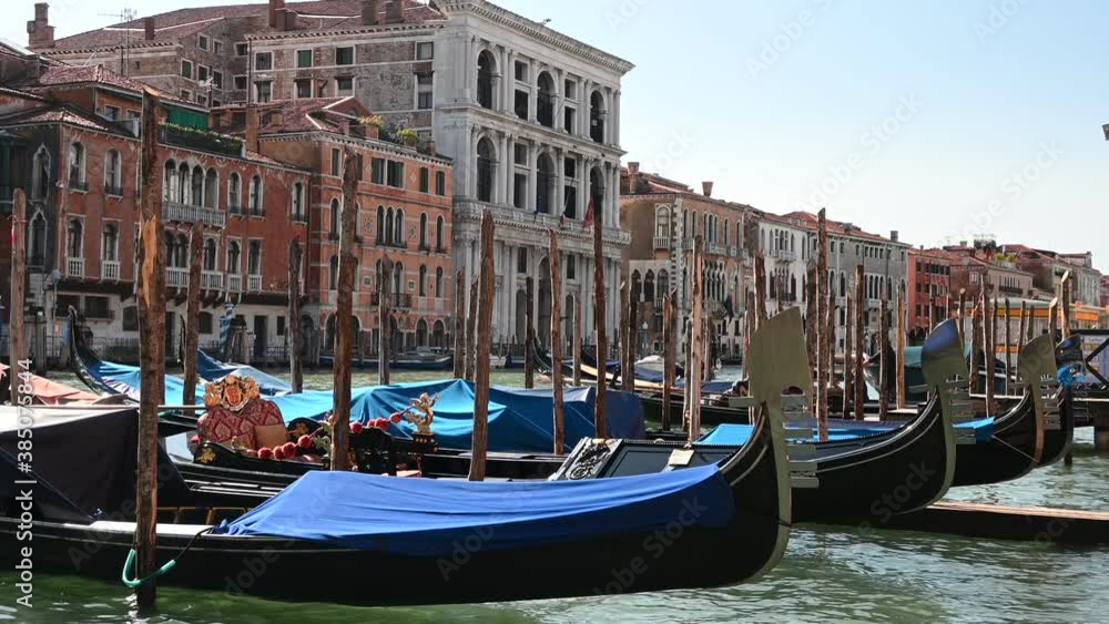 Venice, Italy - gondolas and gondoliers in the Grand Canal near the Rialto Bridge and between the canals of the lagoon city Venice, Italy - gondolas and gondoliers in the Grand Canal near the Rialto Bridge and between the canals of the lagoon city