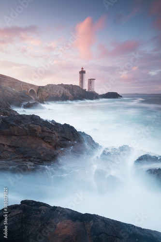 Most popular lighthouse in Europe during stormy weather. Petit Minou Lighthouse at sunset with red light, Brest , France View of Lighthouse of Petit Minou in Brittany. Summer season, France coastline