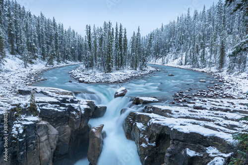 First snow Morning in Jasper National Park Alberta Canada Snow-covered winter landscape in the Sunwapta Falls on Athabasca river. Beautiful background photo. Start ski season.
