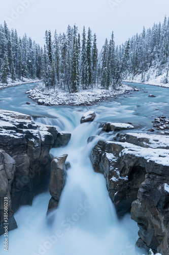 First snow Morning in Jasper National Park Alberta Canada Snow-covered winter landscape in the Sunwapta Falls on Athabasca river. Beautiful background photo. Start ski season.