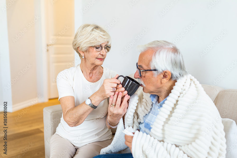 Wife taking care of her sick husband.Senior man having flu. Old people,senior man with winter seasonal illness, fever, cold Wife taking care of her sick husband.Senior man having flu. Old people,senior man with winter seasonal illness, fever, cold