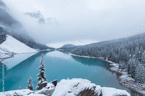 First snow, Morning at Moraine Lake in Banff National Park Alberta Canada Snow-covered winter mountain lake in a winter atmosphere. Beautiful nature background photo. Landscape in the misty weather.