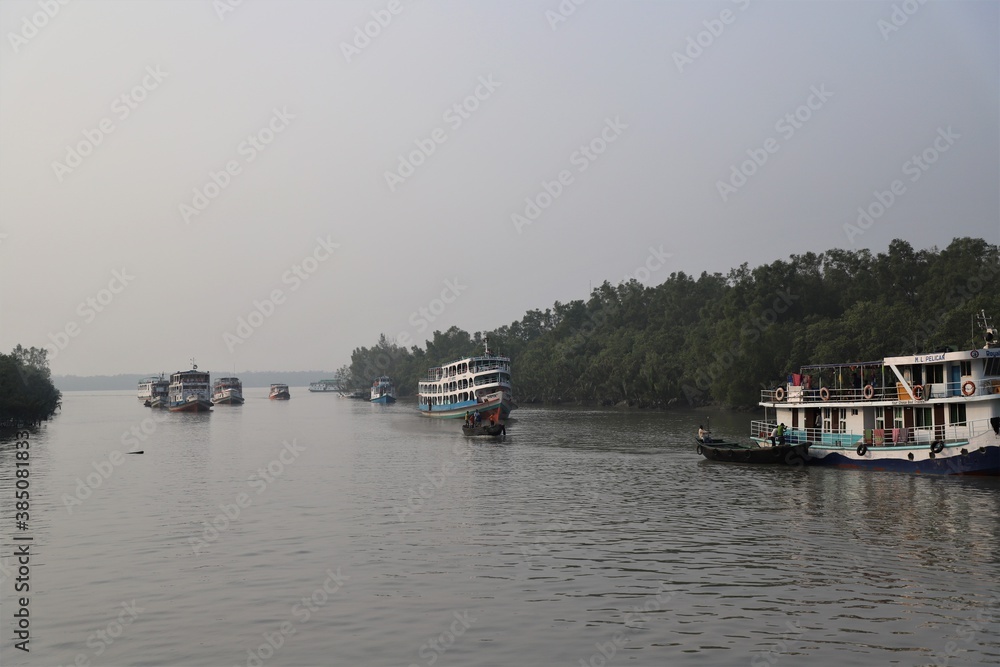 Tourist launches on the river beside the largest mangrove forest Sundarbans in Bangladesh 
