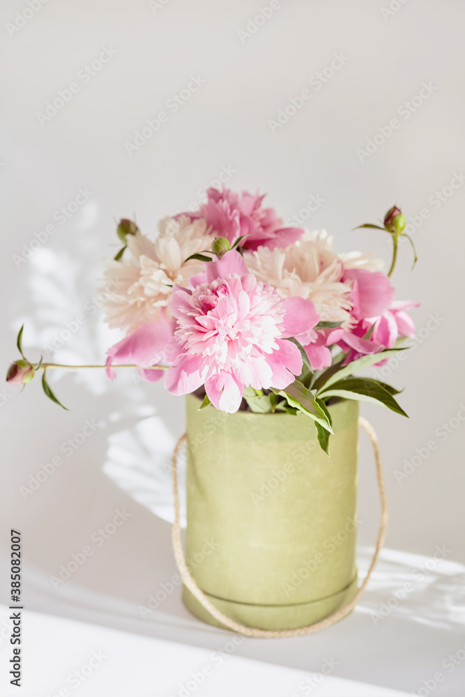 box with fresh pink peonies close-up. soft focus, vintage toning, wedding invitation concept