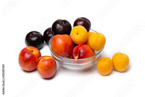 nectarine, peach and plum on a white background