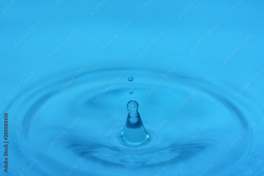Drop falling on the water surface close up with circles on the water Drop falling on the water surface close up with circles on the water