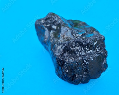 lump of coal on a blue background 