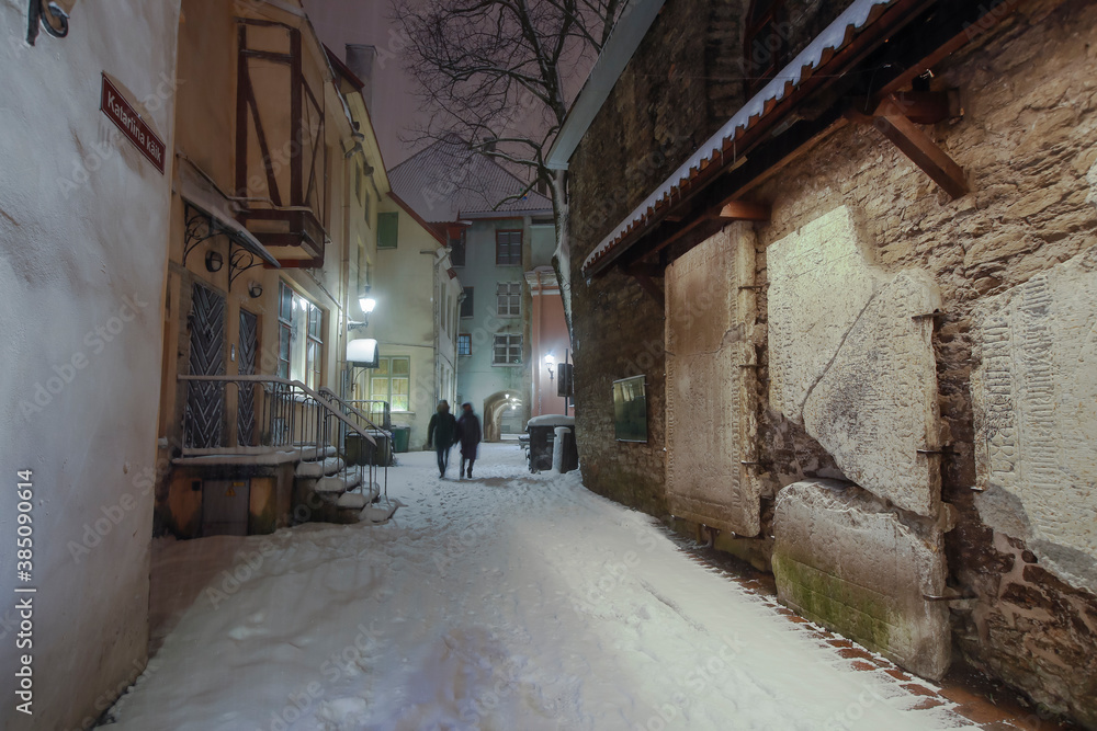 The st Catherine's passage - one of the most picturesque lanes of Old Tallinn and UNESCO cultural heritage site at the heavy winter snowfall night