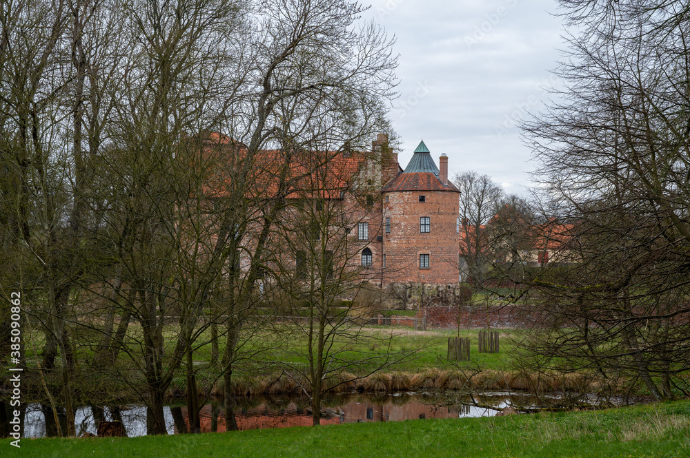 The exterior facade of the castle Torup embedded in the forest in southern Sweden