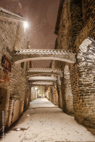The st Catherine s passage - one of the most picturesque lanes of Old Tallinn and Unesco cultural heritage site at the heavy winter snowfall night