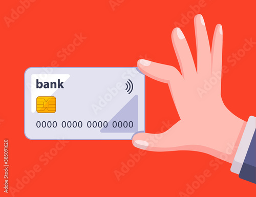 man holds a bank card in his hand on a red background. flat vector illustration.