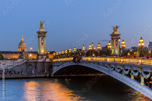 Alexander III Bridge and Les Invalides museum in Paris at night