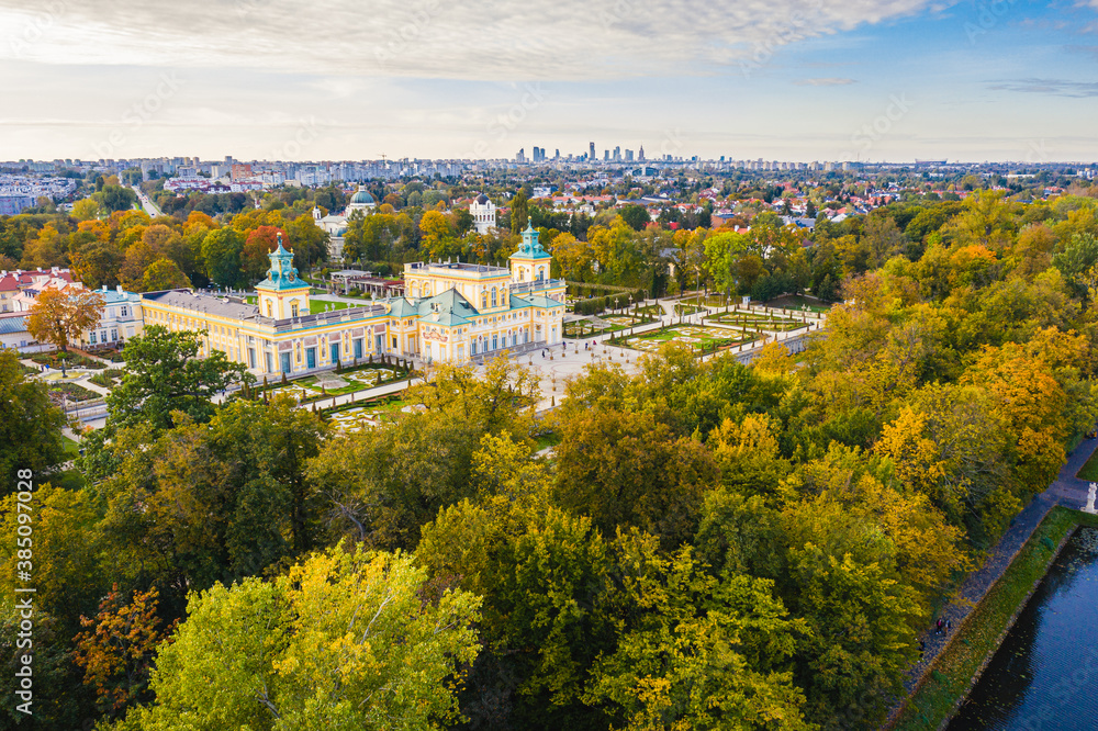 Autumn in Wilanow palace garden, Warsaw distant city center aerial view in the background