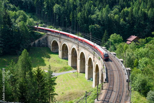 Train on the viaduct over the Adlitzgraben on the Semmering Railway. The Semmering Railway is the oldest mountain railway of Europe and a Unesco World Heritage site.