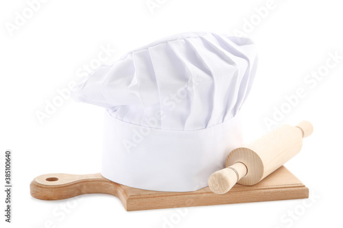 Chef hat with wooden rolling pin and cutting board isolated on white background