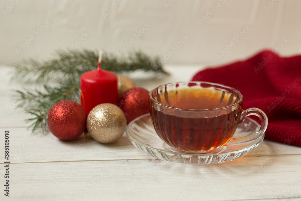 Cup of tea with a candle and Christmas decorations, Christmas tree on a white wooden background. Cup of tea with a candle and Christmas decorations, Christmas tree on a white wooden background.