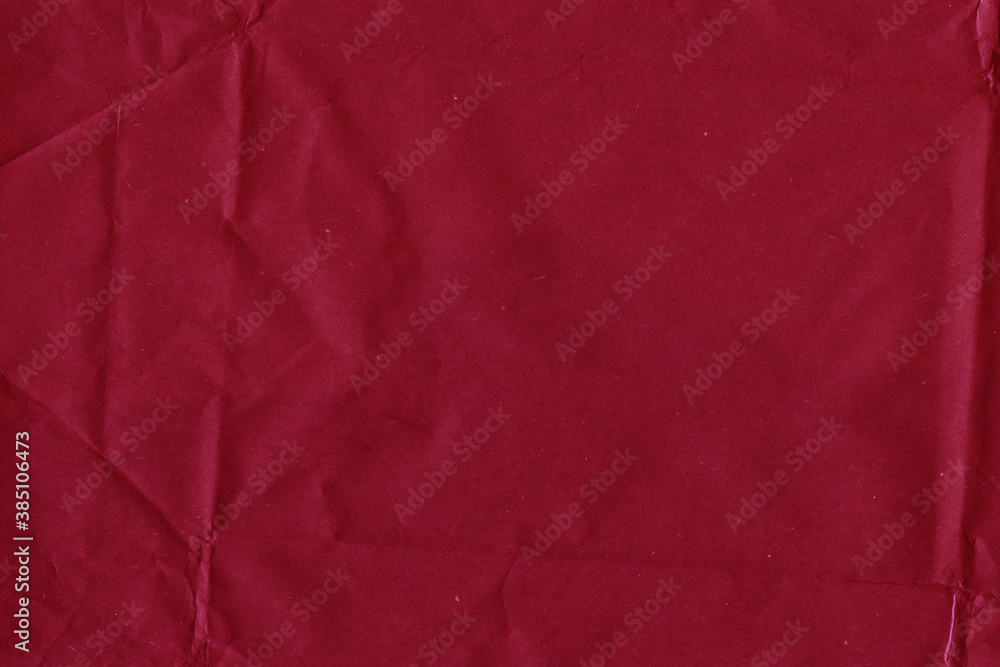Fototapeta premium Red vintage and old looking crumpled paper background. Retro cardboard texture. Grunge paper for drawing. Ancient book page. Present wrapping.