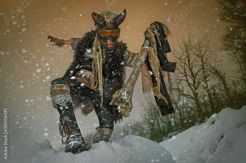 Quadro su tela Tribal costumed person, with a beastly appearance, acting impressively with his