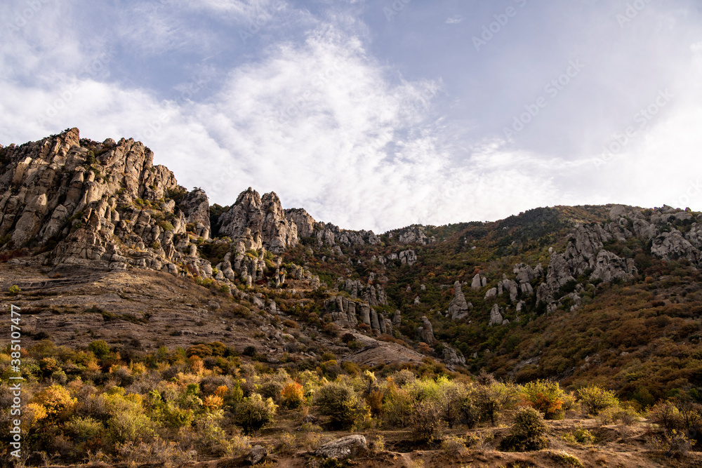 panoramic view of yellow autumn mountains against a background of blue haze and storm clouds