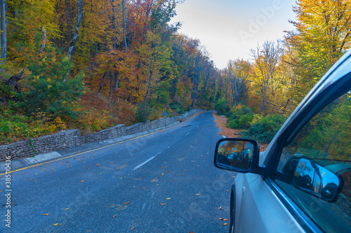 Mountain road through the autumn forest