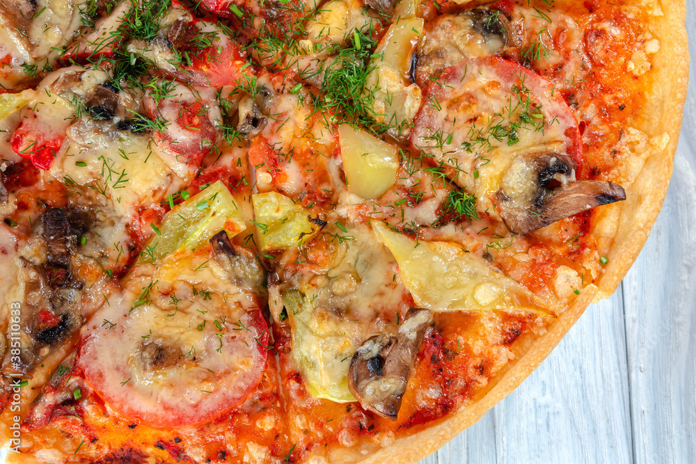 pizza with cheese vegetables and meat on a wooden background pizza with cheese vegetables and meat on a wooden background