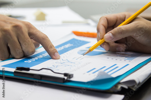Business man Writing expense information in home office.team work concept